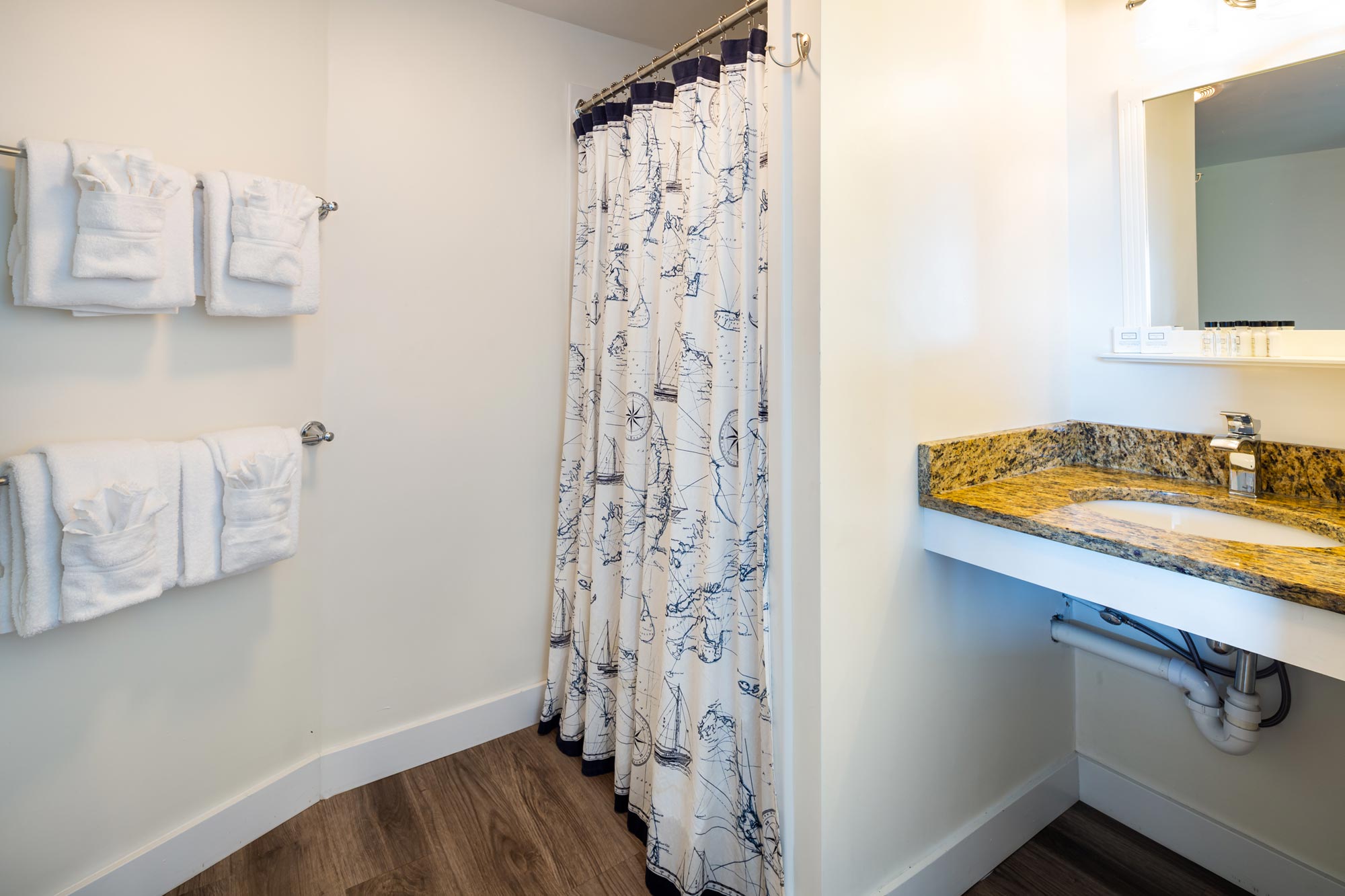 Shower curtain and sink in a hotel bathroom