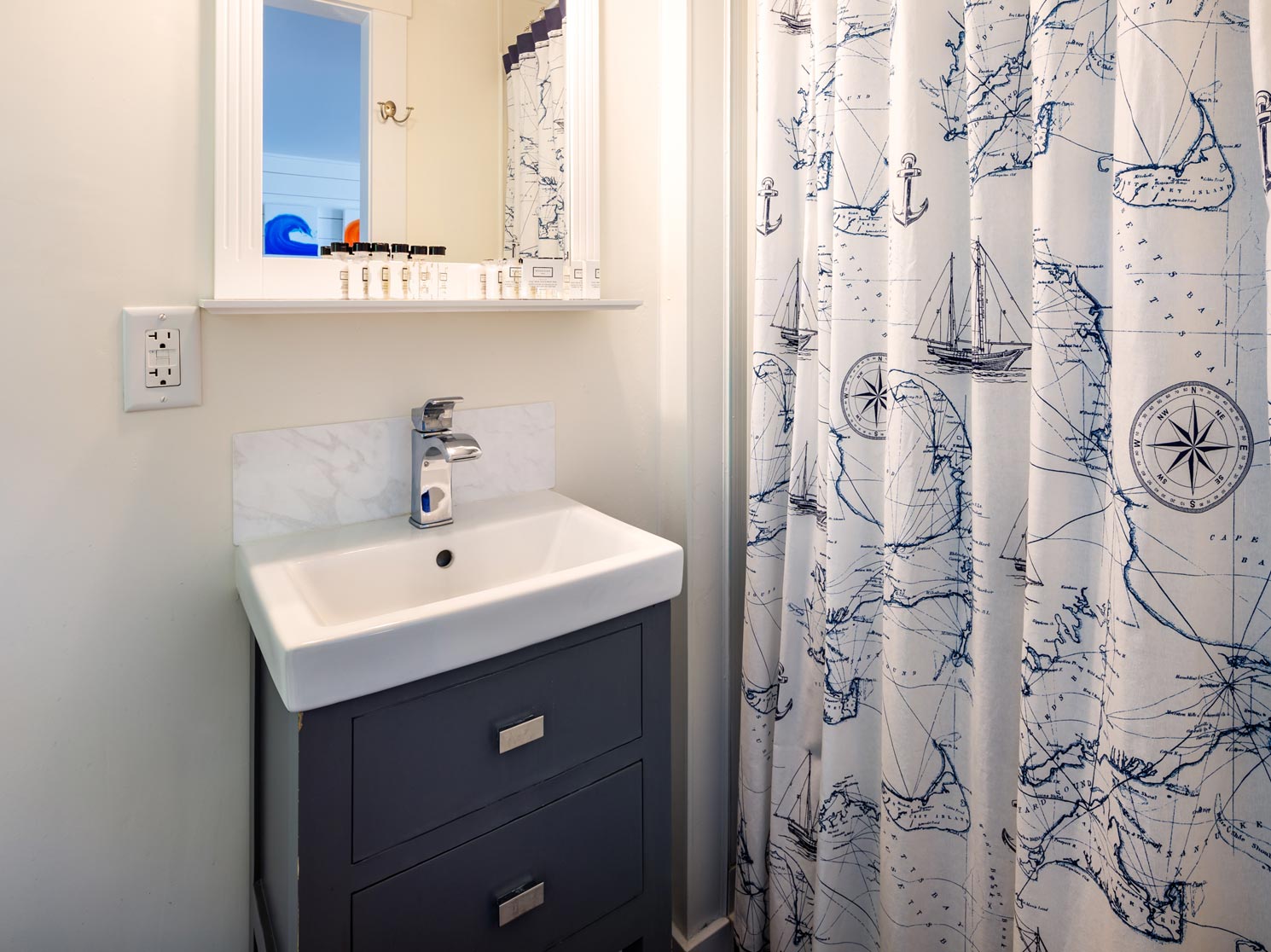 Sink, vanity, and shower in a bright hotel bathroom