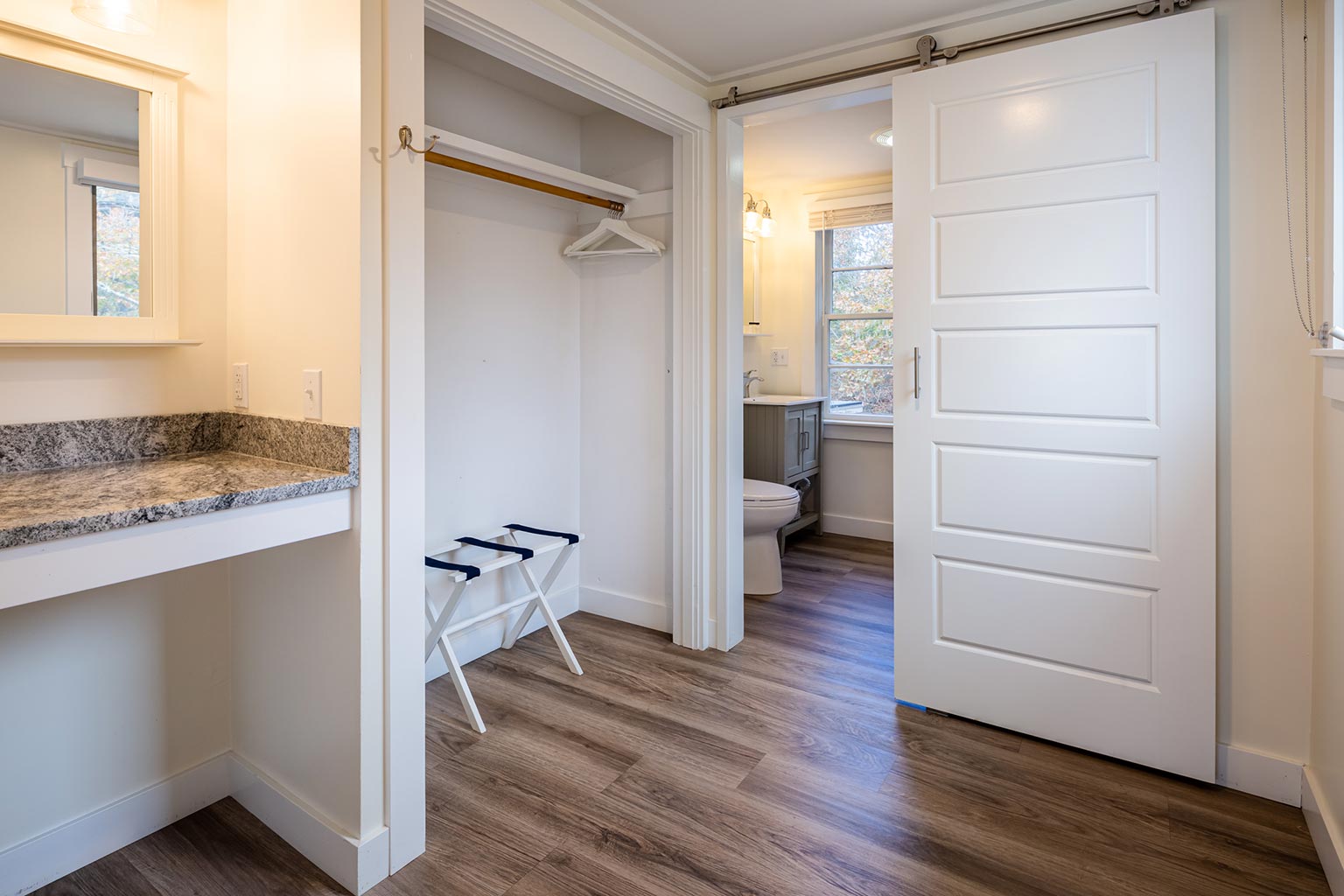 Breakwater hotel suite with closet storage looking into bathroom.
