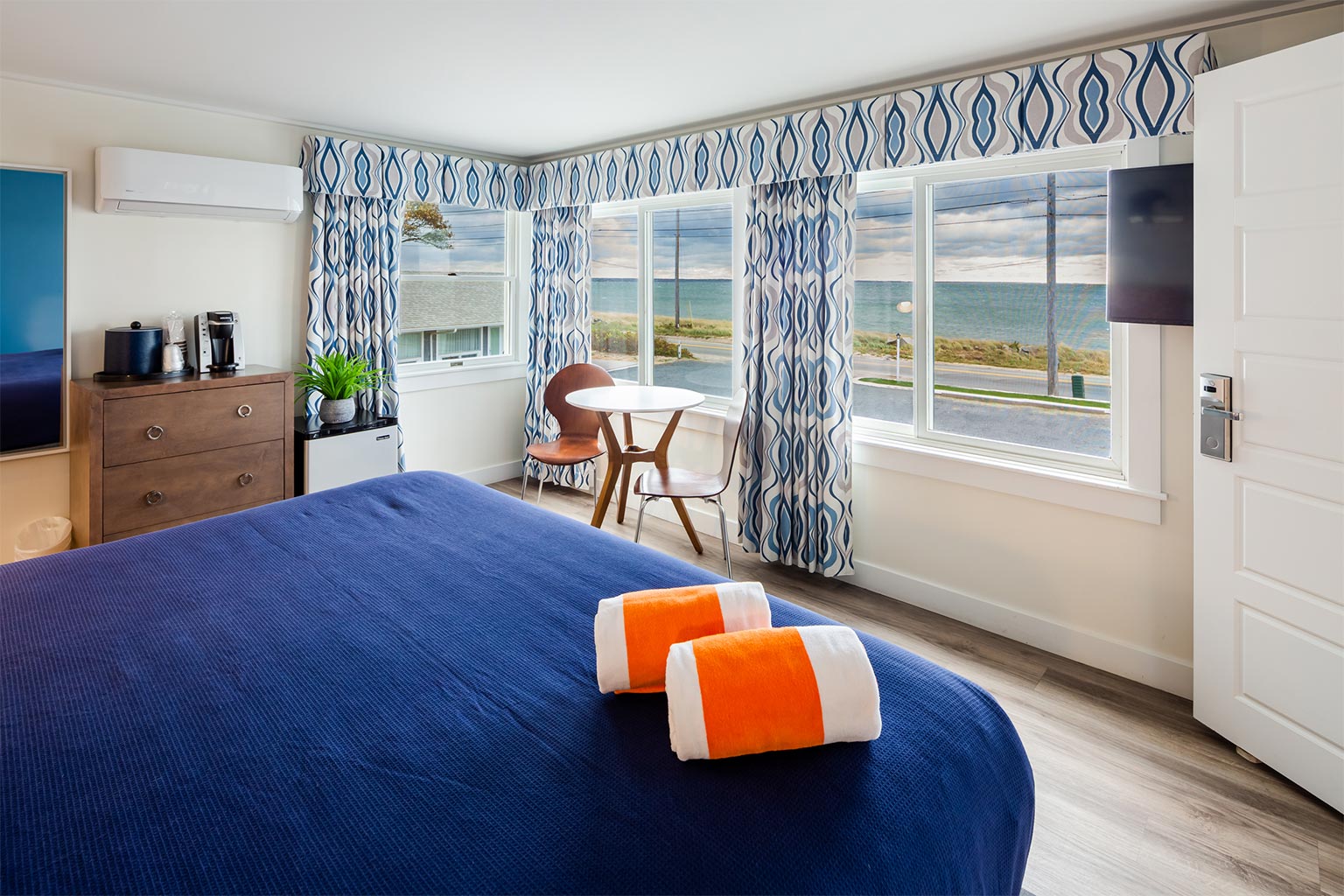 Hotel room with large bed and ocean views.