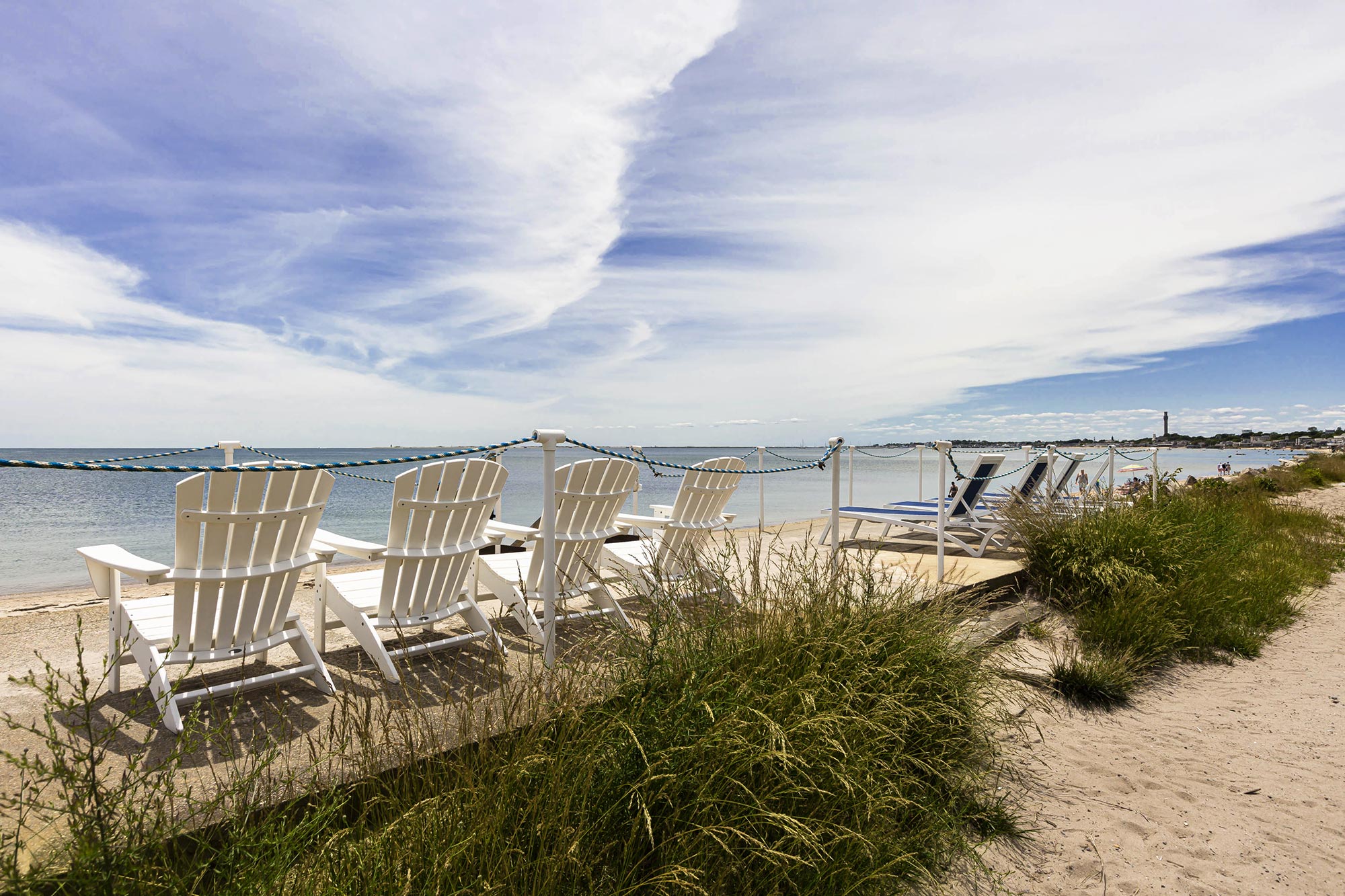 sunny beach lined with beach chairs